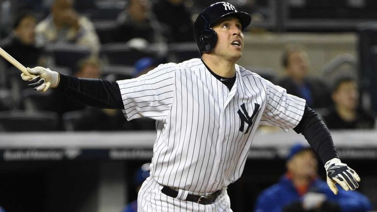 New York Yankees first baseman Mark Teixeira watches the flight of his two-run home run in the third inning against the New York Mets in a baseball game at Yankee Stadium on Friday, April 24, 2015.