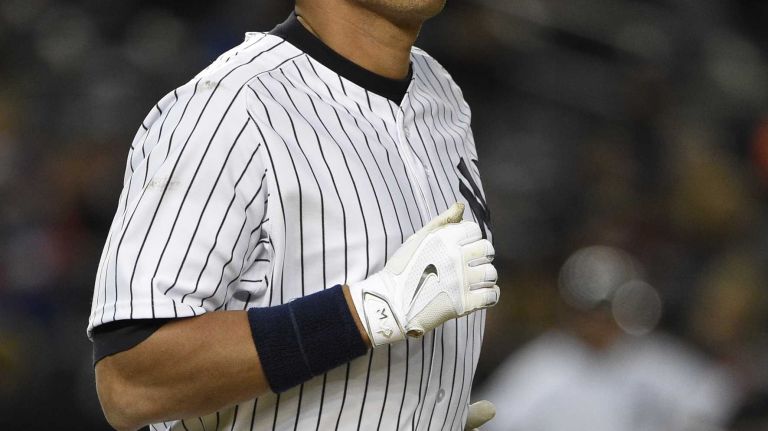 New York Yankees designated hitter Alex Rodriguez runs to first base after drawing a walk against New York Mets starting pitcher Jacob deGrom in the third inning in a baseball game at Yankee Stadium on Friday, April 24, 2015.