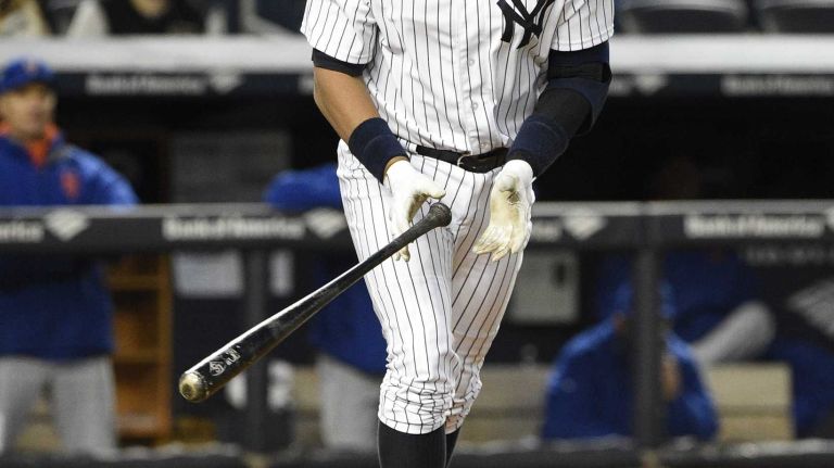 New York Yankees designated hitter Alex Rodriguez tosses his bat after he draws a walk against New York Mets starting pitcher Jacob deGrom in the third inning in a baseball game at Yankee Stadium on Friday, April 24, 2015.