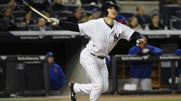 New York Yankees first baseman Mark Teixeira watches the flight of his two-run home run in the third inning against the New York Mets in a baseball game at Yankee Stadium on Friday, April 24, 2015.