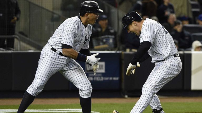 New York Yankees designated hitter Alex Rodriguez and New York Yankees first baseman Mark Teixeira celebrate after Teixeira's two-run home run in the third inning against the New York Mets in a baseball game at Yankee Stadium on Friday, April 24, 2015.
