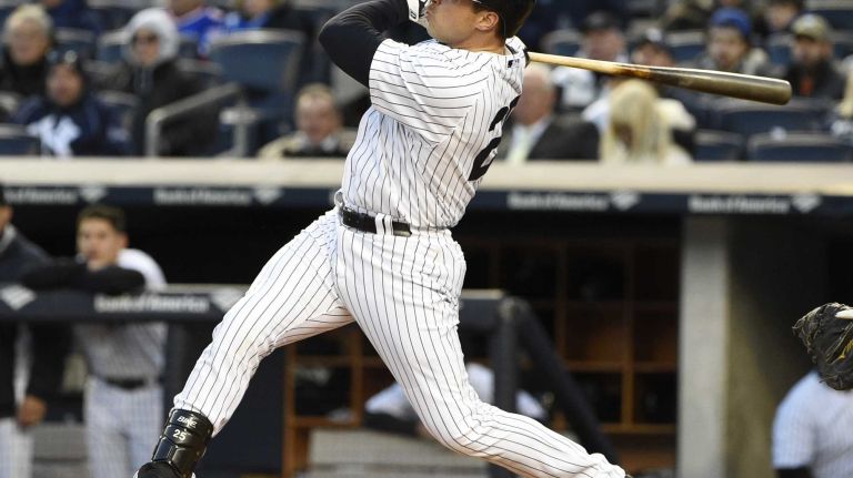 New York Yankees first baseman Mark Teixeira follows through on his two-run home run against the New York Mets in a baseball game at Yankee Stadium on Friday, April 24, 2015.