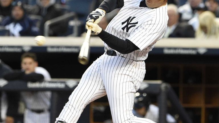 New York Yankees first baseman Mark Teixeira hits a two-run home run against the New York Mets in a baseball game at Yankee Stadium on Friday, April 24, 2015.