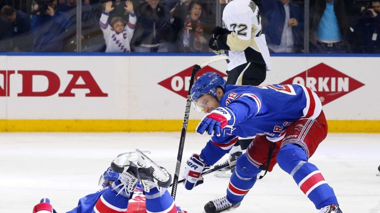 Carl Hagelin #62 of the New York Rangers celebrates his overtime goal against the Pittsburgh Penguins during game five of the Eastern Conference Quarterfinals with teammate Dominic Moore #28 at Madison Square Garden on Friday, Apr. 24, 2015 in New York City.