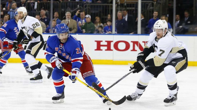 Martin St. Louis of the New York Rangers plays the puck in the second period against Paul Martin of the Pittsburgh Penguins during Game 5 of the Eastern Conference Quarterfinals at Madison Square Garden on Friday, April 24, 2015.