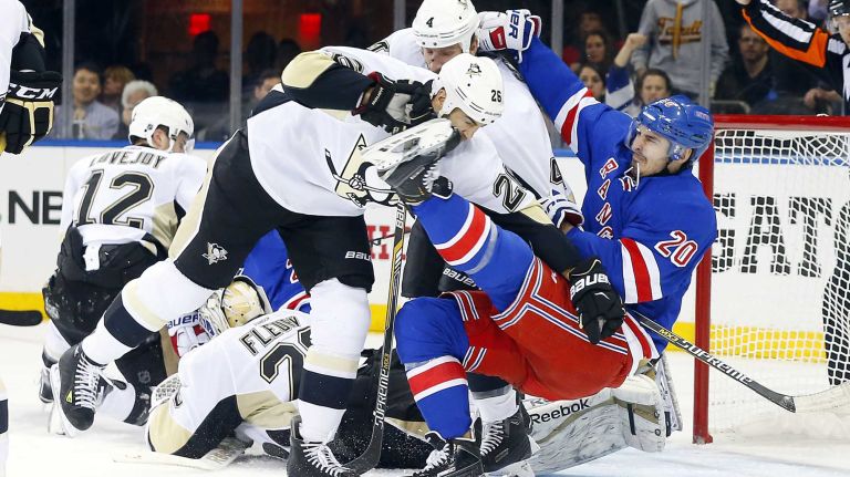 Daniel Winnik of the Pittsburgh Penguins takes down Chris Kreider of the New York Rangers after a whistle in the second period during Game 5 of the Eastern Conference Quarterfinals at Madison Square Garden on Friday, April 24, 2015.