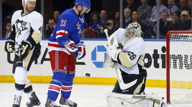 Derek Stepan of the New York Rangers grabs a rebound of a shot against Marc-Andre Fleury of the Pittsburgh Penguins en route to scoring a first-period goal during Game 5 of the Eastern Conference Quarterfinals at Madison Square Garden on Friday, April 24, 2015.