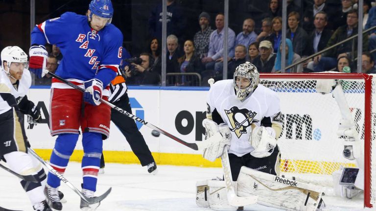 Marc-Andre Fleury of the Pittsburgh Penguins defends his net in the first period under pressure from Rick Nash of the New York Rangers during Game 5 of the Eastern Conference Quarterfinals at Madison Square Garden on Friday, April 24, 2015.