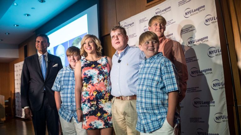 Face transplant recipient Patrick Hardison is joined by his children and NYU surgeon Dr. Eduardo Rodriguez during a press conference at NYU Langone Medical Center, Wednesday Aug. 24, 2016. Hardison talked about the milestones he's reached a year after he underwent the most extensive face transplant ever performed.