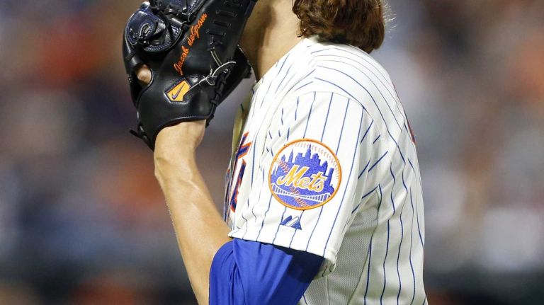 Jacob deGrom #48 of the New York Mets walks to the dugout after the fifth inning against the San Francisco Giants at Citi Field on Saturday, August 2, 2014 in the Queens Borough of New York City.