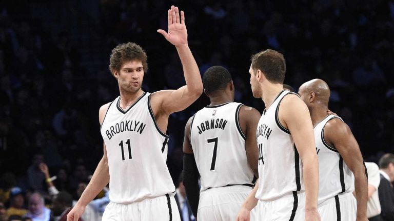 The Brooklyn Nets including center Brook Lopez, left, react late in the second half against the Cleveland Cavaliers in an NBA basketball game at Barclays Center on Friday, March 27, 2015. The Nets defeated the Cavaliers 106-98.