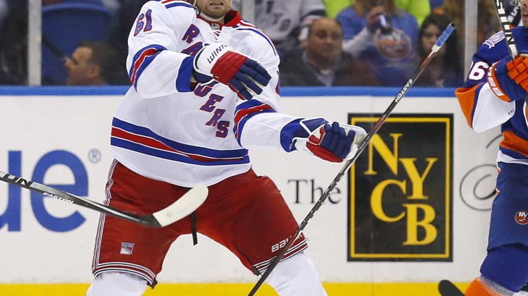Rick Nash 39 Rick Nash of the New York Rangers tries to play the puck in the third period against the New York Islanders at Nassau Coliseum on Tuesday, March 10, 2015.
