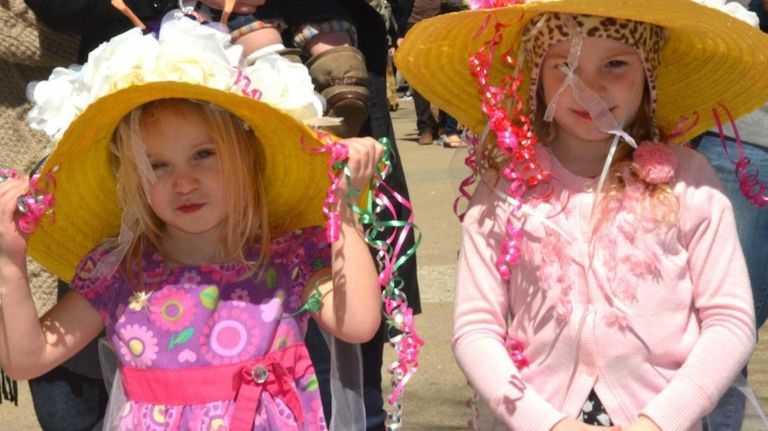Kiera Martin, then 3, of Sag Harbor, left, and her sister Fiona, then 5, march in Sag Harbor's 18th annual sidewalk Easter bonnet parade on Saturday, March 30, 2013. They spent the night before decorating their bonnets.