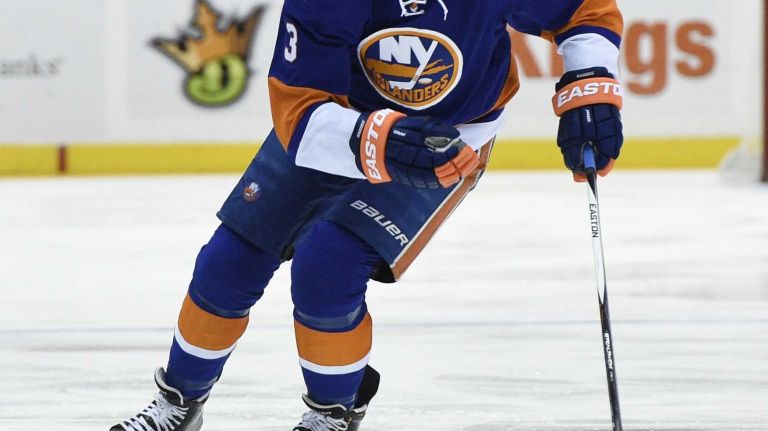 New York Islanders defenseman Travis Hamonic controls the puck against the Los Angeles Kings in the first period of an NHL hockey game at Nassau Coliseum on Thursday, March 26, 2015.