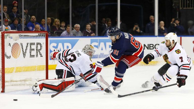 Rick Nash of the New York Rangers misses a third-period scoring chance against Scott Darling and Brent Seabrook of the Chicago Blackhawks at Madison Square Garden on Wednesday, March 18, 2015.