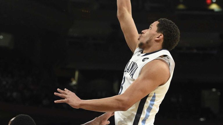 Villanova Wildcats guard Josh Hart sinks a layup past Xavier Musketeers forward James Farr during the final game of the Big East basketball tournament at Madison Square Garden on Saturday, March 14, 2015.