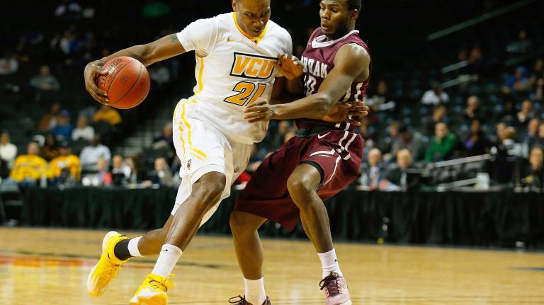 NEW YORK, NY - MARCH 12: Treveon Graham #21 of the Virginia Commonwealth Rams drives to the nets against Jon Severe #10 of the Fordham Rams during the Second Round of the Atlantic 10 Basketball Tournament at Barclays Center on March 12, 2015 in the Brooklyn borough of New York City. (Photo by Mike Stobe/Getty Images)