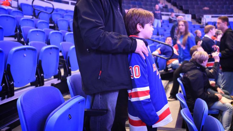 Fans at Islanders vs. Rangers 34 Rangers fan John Sausa takes his eight-year old son Evan to his first live hockey game at Nassau Coliseum for the last Islanders-Rangers regular-season game at the Coliseum on March 10, 2015.