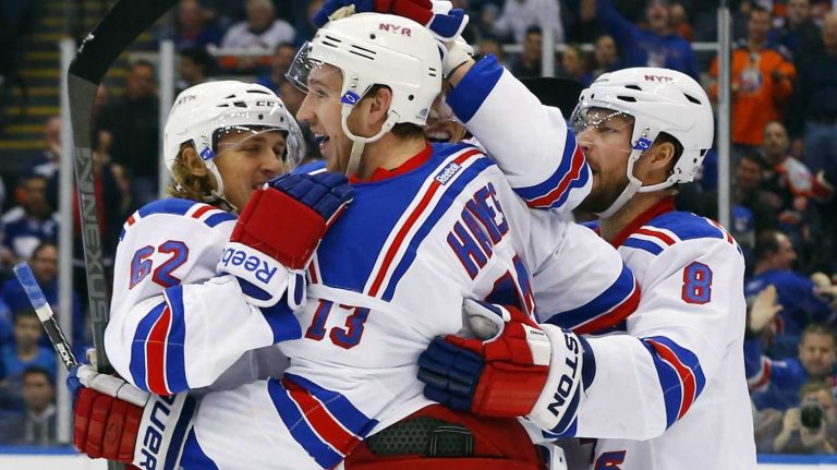 Kevin Hayes of the New York Rangers celebrates his second-period goal against the New York Islanders with his teammates at Nassau Coliseum on Tuesday, March 10, 2015.