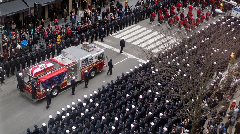 The casket carrying FDNY firefighter Michael Davidson is carried on a fire truck after being walked from St. Patrick's Cathedral on Tuesday.