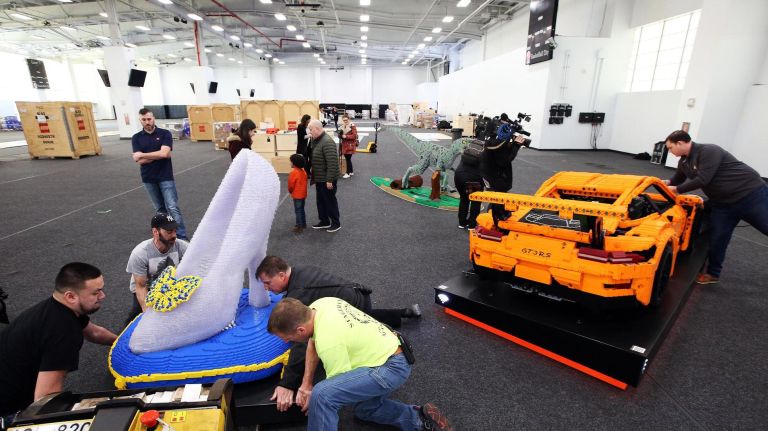 Workers unpack a Lego Cinderella shoe made from 15,000 blocks, as they prepare for the inaugural Lego Live NYC display at Pier 36.
