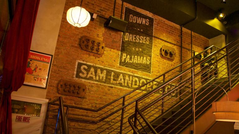 ...the exposed brick wall evokes the factory floor. The painted sign here isn't original, but it does replicate a couple you'll still see faintly on the western side of the building at 70 W. 36th St.