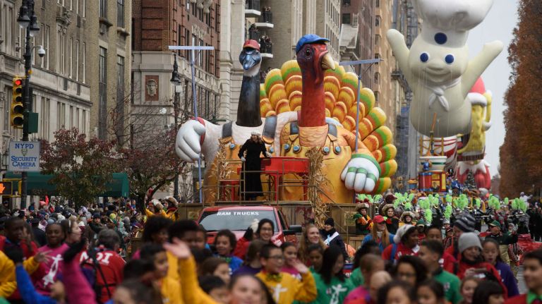 The Tom Turkey rolling float followed by the Pillsbury Doughboy balloon travel along Central Park West on Thursday, Nov. 24, 2016, at the start of the 90th Macy's Thanksgiving Day Parade in Manhattan.