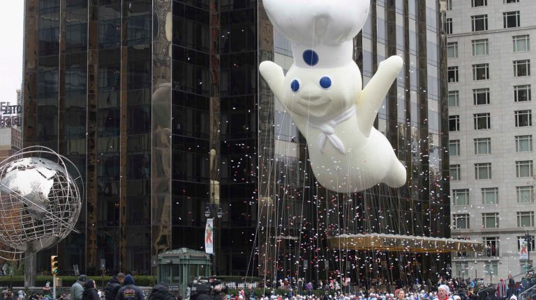 Pillsbury Doughboy balloons looks like it's flying as it moves over Central Park South on Thursday, Nov. 24, 2016, during the 90th Macy's Thanksgiving Day Parade in Manhattan.