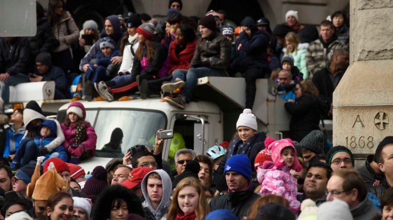Spectators sit on sand trucks along the route of 90thannual Macy's Thanksgiving Day Parade in Manhattan on Thursday, Nov. 24, 2016. The NYPD increased security along the 2.5 mile public route.