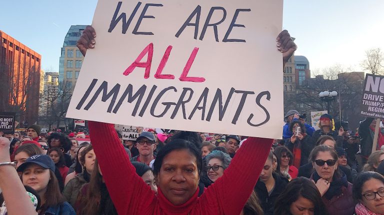 A woman holds a protest sign during the International Women's Strike rally in Manhattan's Washington Square Park on Wednesday, March 8, 2017.