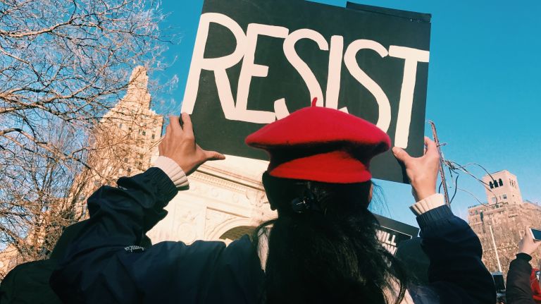 A woman holds a protest sign during the International Women's Strike rally in Manhattan's Washington Square Park on Wednesday, March 8, 2017.
