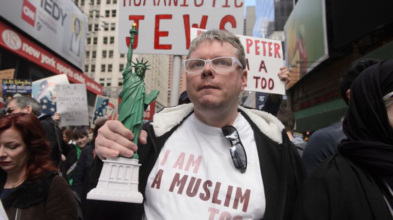 A man holds a Statue of Liberty figurine at the I Am A Muslim Too rally in Times Square on Feb. 19, 2017.