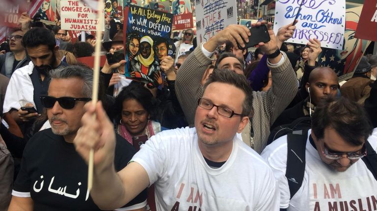 A participant holds the American flag at the I Am A Muslim Too rally in Times Square on Feb. 19, 2017.
