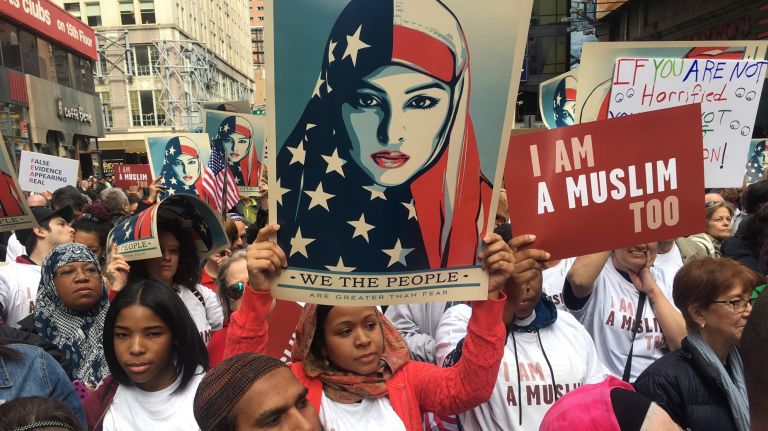 Participants hold signs at the Times Square rally on Feb. 19, 2017. 