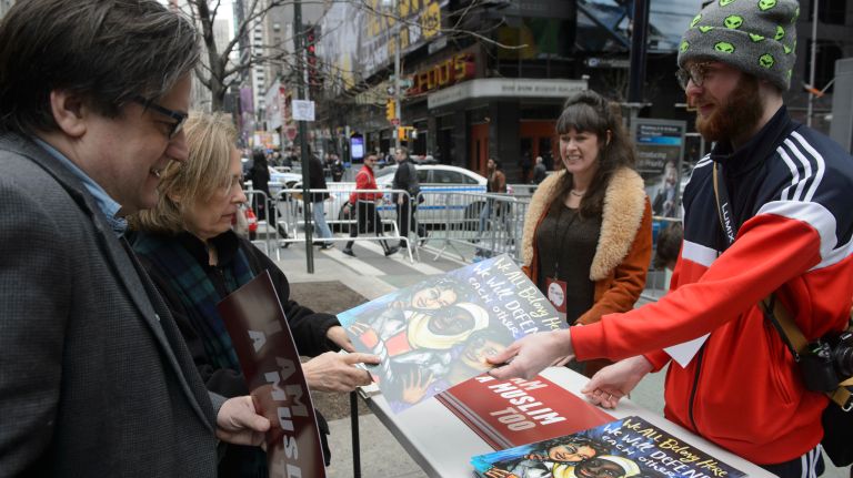 Organizers hand out signs and posters at the I Am A Muslim Too rally in Times Square on Feb. 19, 2017. 