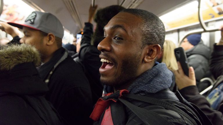 Passengers cheer as they ride a northbound Q train during the first day of service on the Second Avenue subway on Sunday, Jan. 1, 2017.
