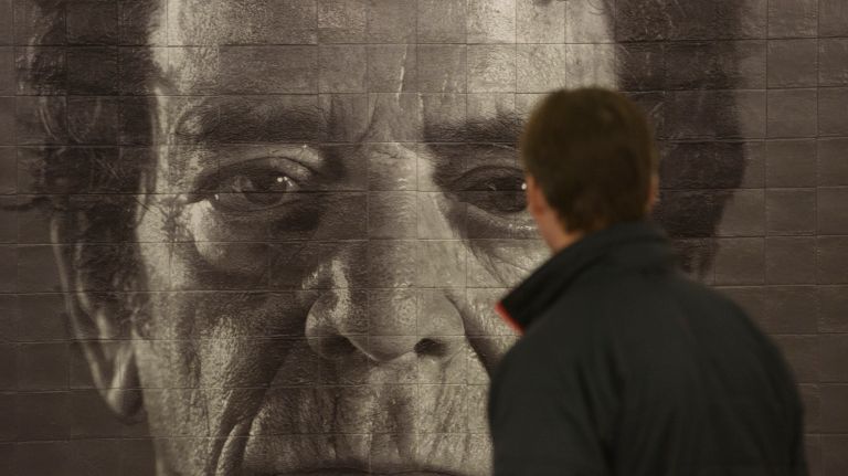 People look at artwork by Chuck Close in the Second Avenue subway's 86th Street station on the first day that the new line opened to the public, Sunday, Jan. 1, 2017.
