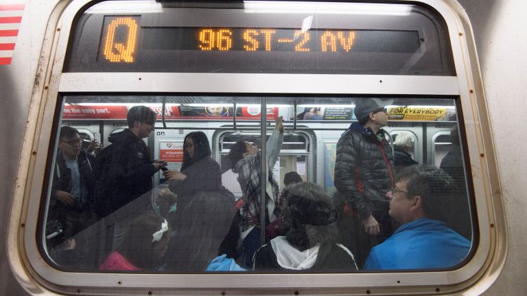 Passengers ride a northbound Q train during the first day of service on the Second Avenue subway on Sunday, Jan. 1, 2017.
