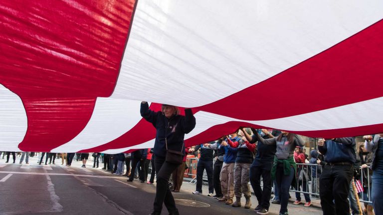 Members of the Ground Zero Volunteer Flag organization walk with a 60x30 foot American Flag.The New York City Veterans Day Parade, also known as America's Parade, on Nov. 11, 2016, marched up Fifth Avenue after a wreath was placed at the Eternal Light Monument at Madison Square Park on 26th St.