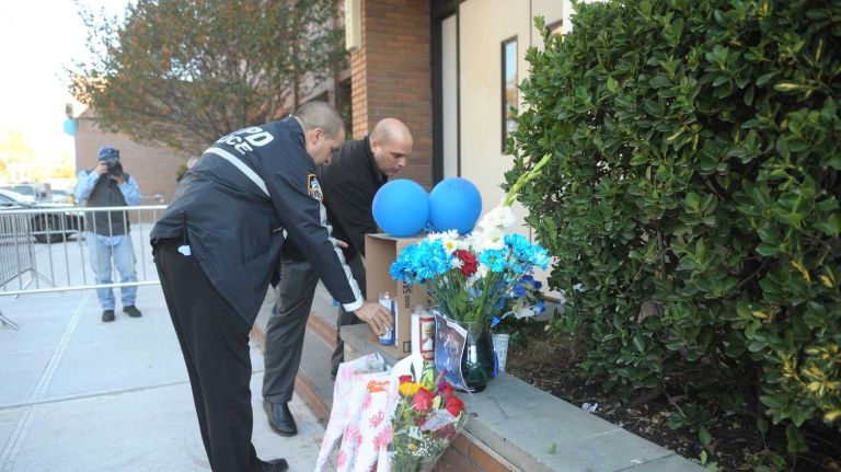 Bronx police shooting: Photos from the scene and more 29 NYPD detectives contribute to a makeshift memorial set up outside the 43rd Precinct station house in the Bronx on Saturday, Nov. 5, 2016.