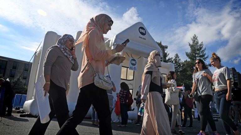 Presidential debate at Hofstra: Photos from the scene 30 Women walk past a giant White House bouncy castle at Hofstra University on Sept. 26, 2016