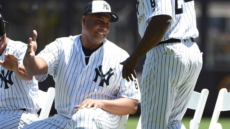 Former New York Yankees players Bernie Williams and Rickey Henderson greet each other on the field during the 70th annual Old-Timers' Day at Yankee Stadium on Sunday, June 12, 2016.