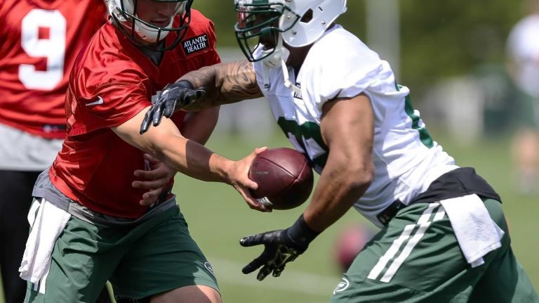 Jets quarterback Christian Hackenberg hands off to running back Matt Forte during the Jets' OTAs on Wednesday, June 1, 2016 in Florham Park, N.J.
