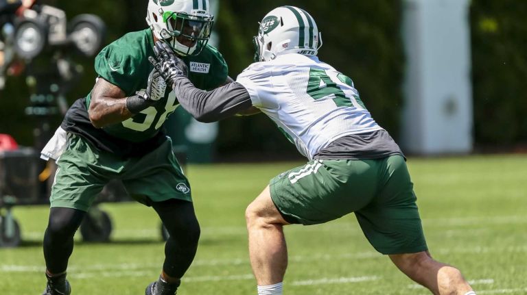 Erin Henderson (#58) of the Jets works against Julian Howsare (#43) during the Jets' OTAs on Wednesday, June 1, 2016 in Florham Park, N.J.