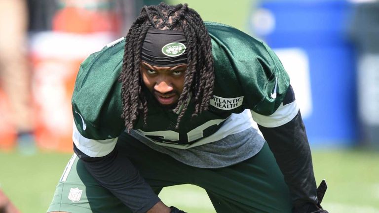 New York Jets cornerback Marcus Williams stretches during warmup at Organized Team Activities at the Jets Training Center on Wednesday, May 25, 2016.