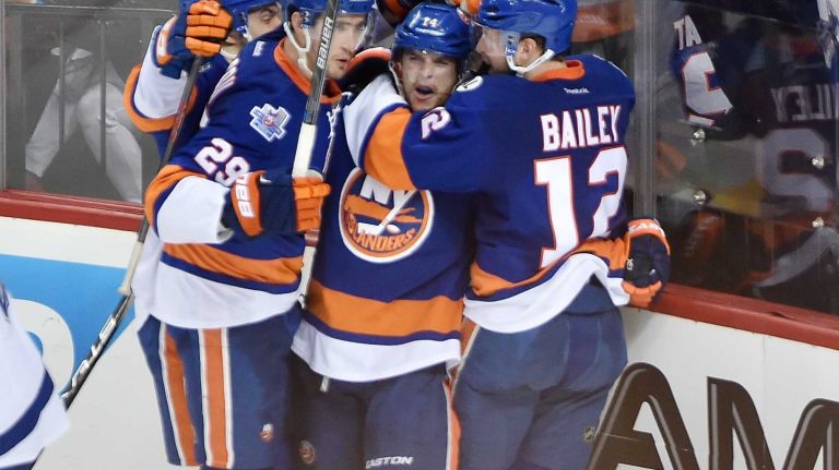 New York Islanders left wing Josh Bailey (12) is mobbed by teammates after scoring the go-ahead goal in the third period in Game 3 of the Eastern Conference semifinals against the Tampa Bay Lightning on Tuesday, May 3, 2016 at Barclays Center.