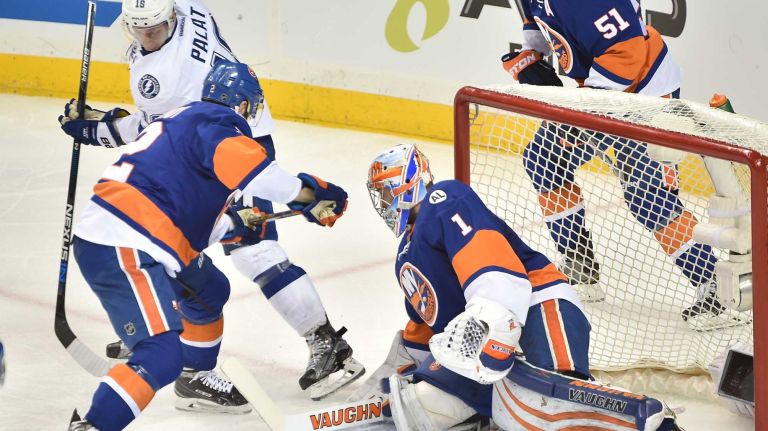 Tampa Bay Lightning left wing Ondrej Palat (18) and New York Islanders defenseman Nick Leddy (2) battle in front of the net with goalie Thomas Greiss (1) defending in the second period in Game 3 of the Eastern Conference semifinals on Tuesday, May 3, 2016 at Barclays Center.