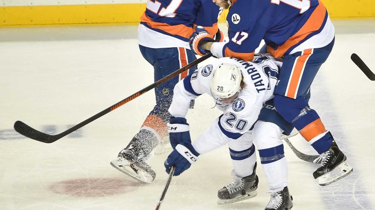 Tampa Bay Lightning defenseman Matt Taormina (20) and New York Islanders left wing Matt Martin (17) battle in the first period in Game 3 of the Eastern Conference semifinals on Tuesday, May 3, 2016 at Barclays Center.