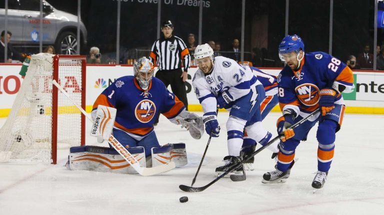 New York Islanders goalie Thomas Greiss (1) stops the shot as Tampa Bay Lightning right wing Ryan Callahan (24) goes after the puck with New York Islanders defenseman Marek Zidlicky (28) in the first period in Game 3 of the Eastern Conference semifinals against the Tampa Bay Lightning on Tuesday, May 3, 2016 at Barclays Center.