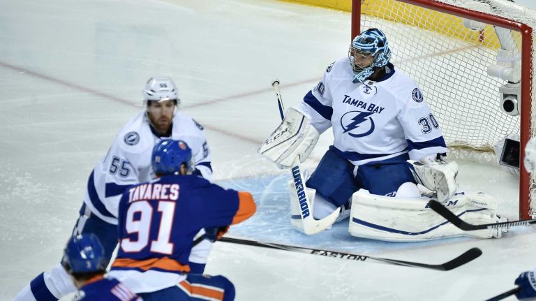 New York Islanders center John Tavares (91) and Tampa Bay Lightning defenseman Braydon Coburn (55) battle as Tampa Bay Lightning goalie Ben Bishop (30) defends the goal in the first period in Game 3 of the Eastern Conference semifinals on Tuesday, May 3, 2016 at Barclays Center.